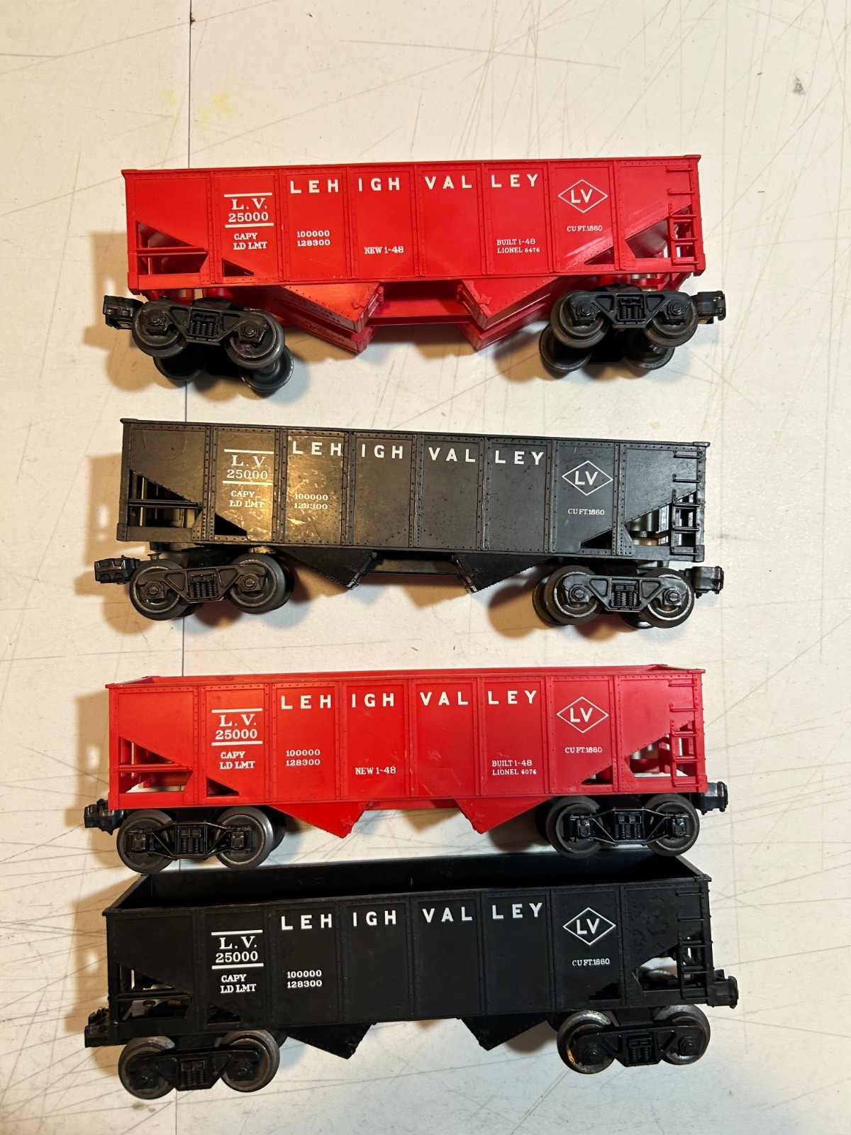 FOUR LIONEL LEHIGH VALLEY COAL HOPPERS, 6076, 6476 AND UNKNOWN