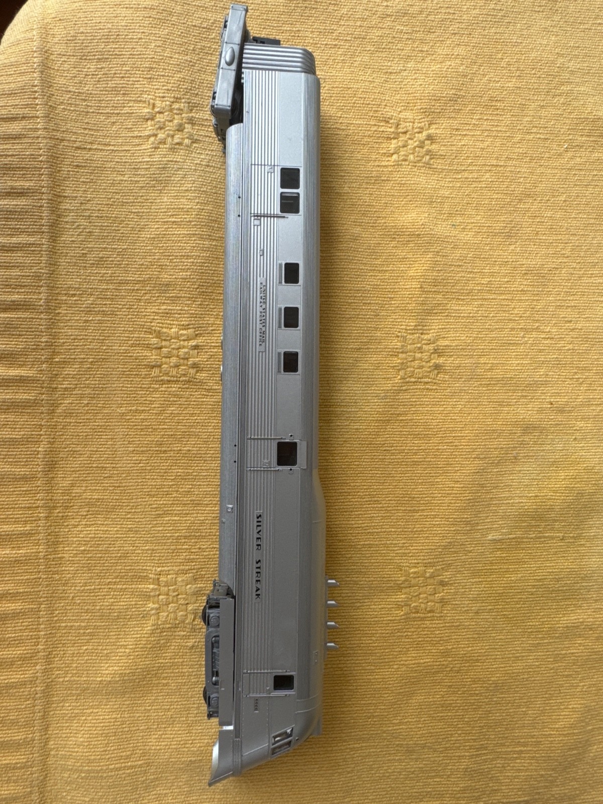 Vintage model train car labeled ‘Silver Streak, likely a passenger car